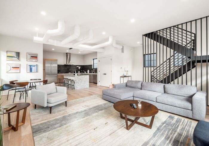 Comfortable living room of our Columbus House that is connected to a half bath and laundry room