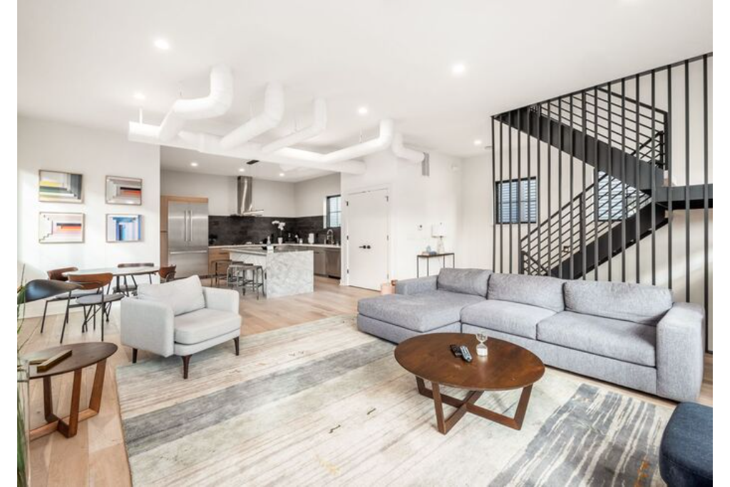Comfortable living room of our Columbus House that is connected to a half bath and laundry room